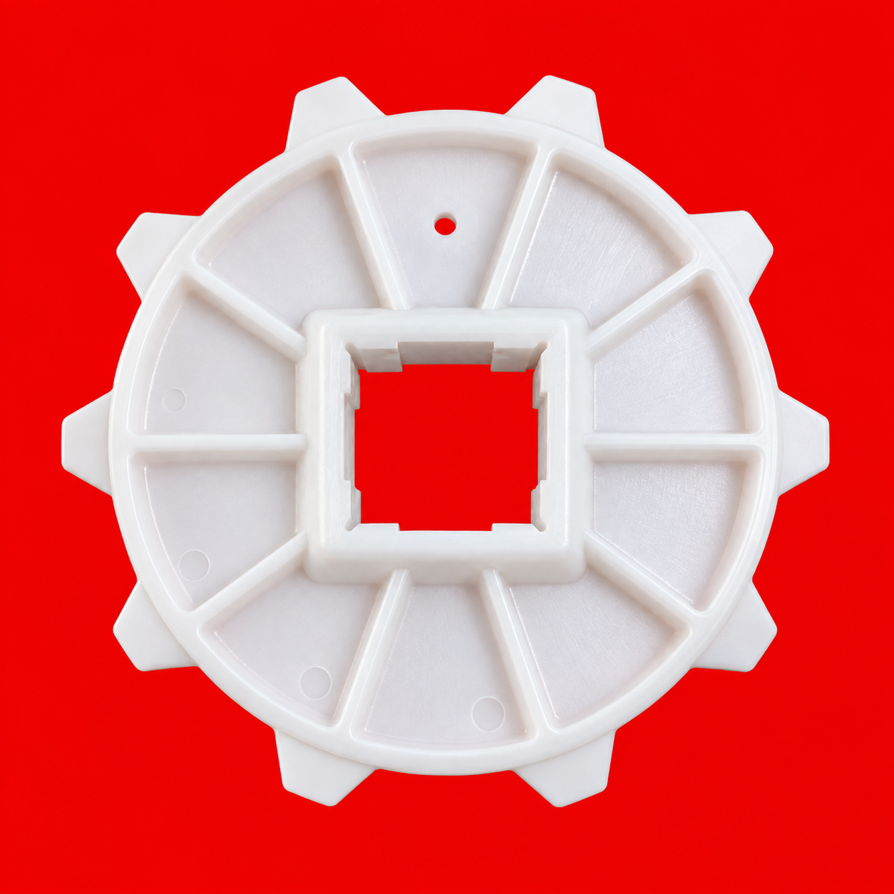 Engranaje plástico blanco sobre rojo (1)