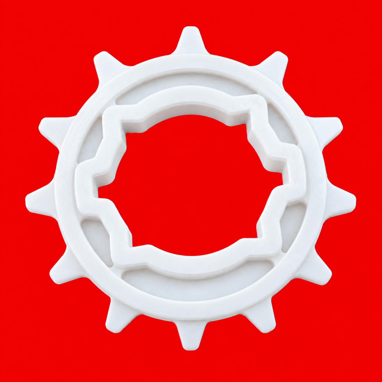 Engranaje plástico blanco sobre rojo